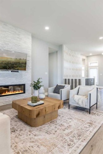 57 Hamptons Gate Se, Medicine Hat, AB - Indoor Photo Showing Living Room With Fireplace