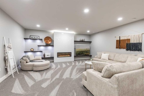 57 Hamptons Gate Se, Medicine Hat, AB - Indoor Photo Showing Basement With Fireplace