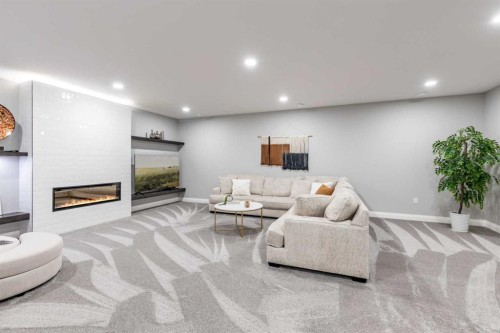 57 Hamptons Gate Se, Medicine Hat, AB - Indoor Photo Showing Basement With Fireplace