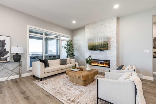 57 Hamptons Gate Se, Medicine Hat, AB - Indoor Photo Showing Living Room With Fireplace