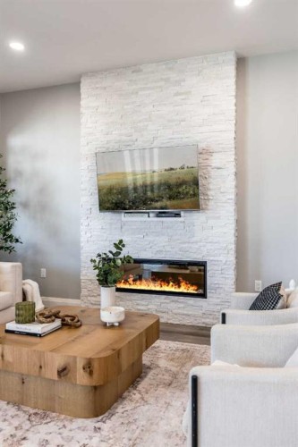 57 Hamptons Gate Se, Medicine Hat, AB - Indoor Photo Showing Living Room With Fireplace