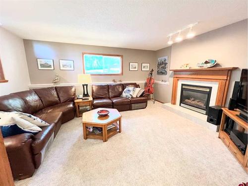 4506 Hees Drive, Athabasca, AB - Indoor Photo Showing Living Room With Fireplace