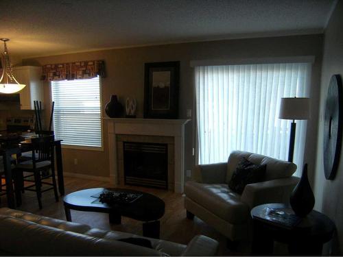 104-2814 48 Avenue, Athabasca, AB - Indoor Photo Showing Living Room With Fireplace