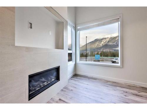 64-209 Stewart Creek Rise, Canmore, AB - Indoor With Fireplace