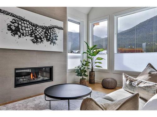 62-209 Stewart Creek Rise, Canmore, AB - Indoor Photo Showing Living Room With Fireplace