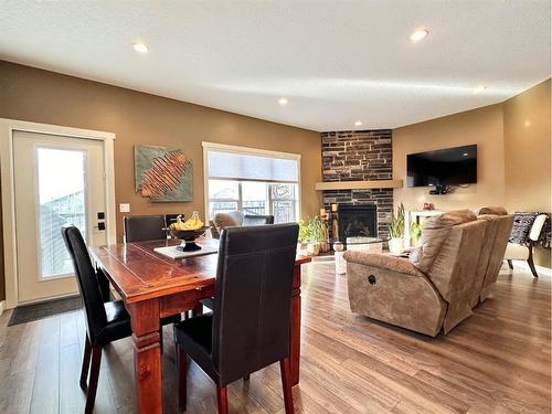 2 Rockhaven Way, Whitecourt, AB - Indoor Photo Showing Dining Room With Fireplace
