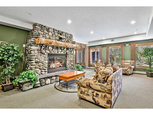 313-155 Crossbow Place, Canmore, AB - Indoor Photo Showing Living Room With Fireplace
