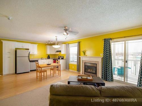 203-2814 48 Avenue, Athabasca, AB - Indoor Photo Showing Living Room With Fireplace