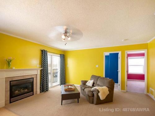 203-2814 48 Avenue, Athabasca, AB - Indoor Photo Showing Living Room With Fireplace