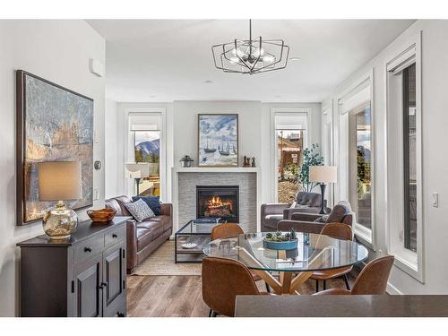 204I-209 Stewart Creek Rise, Canmore, AB - Indoor Photo Showing Living Room With Fireplace