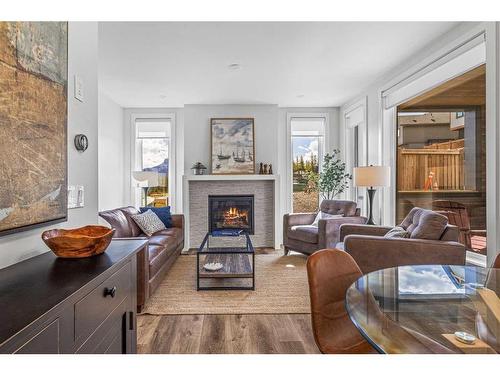 204I-209 Stewart Creek Rise, Canmore, AB - Indoor Photo Showing Living Room With Fireplace