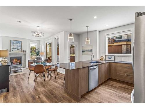 204I-209 Stewart Creek Rise, Canmore, AB - Indoor Photo Showing Kitchen With Fireplace With Upgraded Kitchen