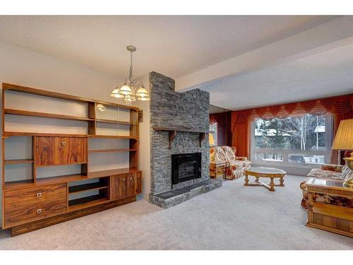 128 Nahanni Drive, Banff, AB - Indoor Photo Showing Living Room With Fireplace