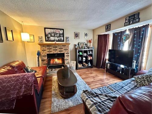 21 Hollinger Drive, Swan Hills, AB - Indoor Photo Showing Living Room With Fireplace