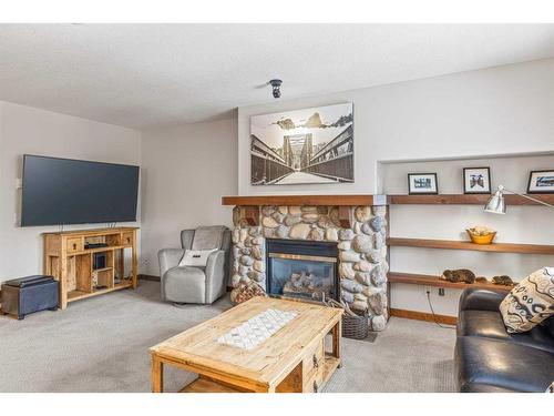 306-170 Crossbow Place, Canmore, AB - Indoor Photo Showing Living Room With Fireplace