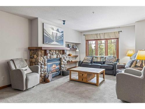 306-170 Crossbow Place, Canmore, AB - Indoor Photo Showing Living Room With Fireplace