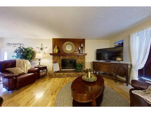 908 14 Avenue Se, Slave Lake, AB - Indoor Photo Showing Living Room With Fireplace