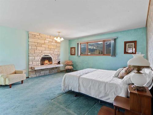 285 Grizzly Crescent, Canmore, AB - Indoor Photo Showing Bedroom With Fireplace