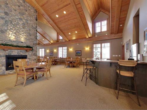 311-150 Crossbow Place, Canmore, AB - Indoor Photo Showing Dining Room With Fireplace