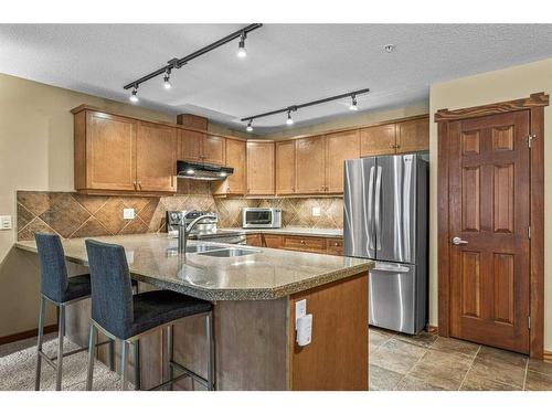 311-150 Crossbow Place, Canmore, AB - Indoor Photo Showing Kitchen With Double Sink