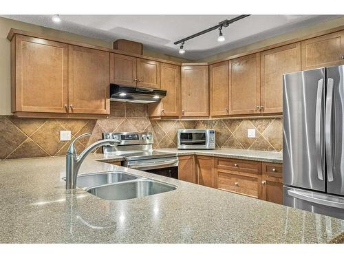 311-150 Crossbow Place, Canmore, AB - Indoor Photo Showing Kitchen With Double Sink