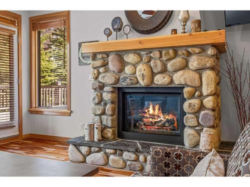 309-701 Benchlands Trail, Canmore, AB - Indoor Photo Showing Living Room With Fireplace