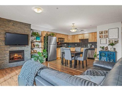 302-300 Palliser Lane, Canmore, AB - Indoor Photo Showing Living Room With Fireplace