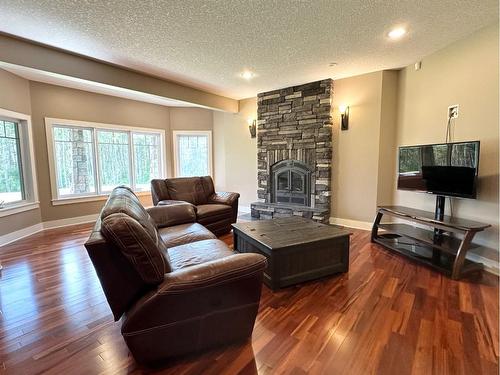 584064 Range Road 121, Rural Woodlands County, AB - Indoor Photo Showing Living Room With Fireplace