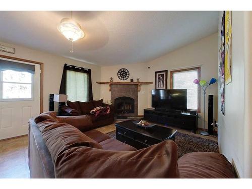 32 1 Avenue Sw, Faust, AB - Indoor Photo Showing Living Room With Fireplace