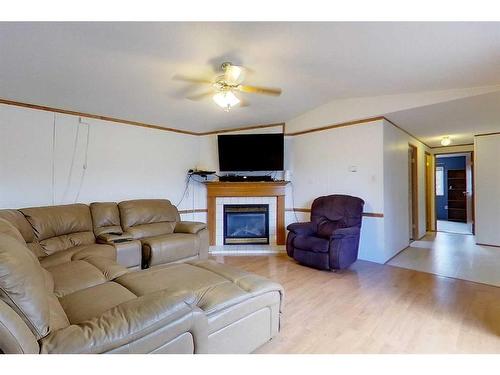 2741 Blueberry Street, Wabasca, AB - Indoor Photo Showing Living Room With Fireplace