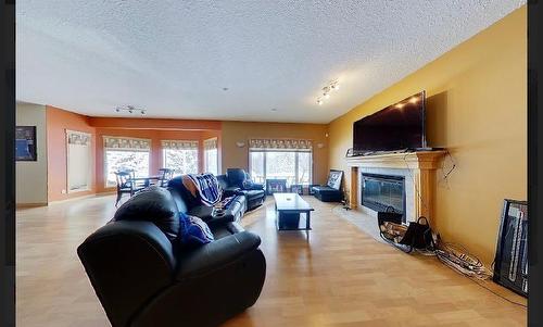 29 594028 Range Road 125, Rural Woodlands County, AB - Indoor Photo Showing Living Room With Fireplace