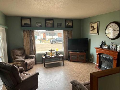 805 8 Street, Fox Creek, AB - Indoor Photo Showing Living Room With Fireplace