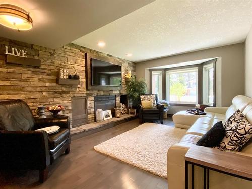 48 Ravine Drive, Whitecourt, AB - Indoor Photo Showing Living Room With Fireplace