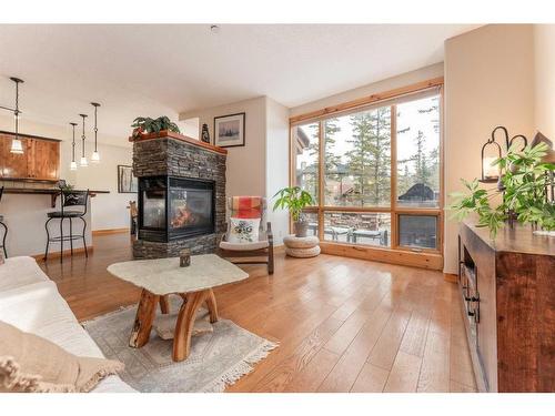 215-107 Armstrong Place, Canmore, AB - Indoor Photo Showing Living Room With Fireplace