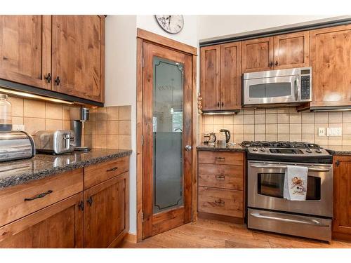 215-107 Armstrong Place, Canmore, AB - Indoor Photo Showing Kitchen With Stainless Steel Kitchen