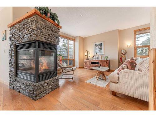 215-107 Armstrong Place, Canmore, AB - Indoor Photo Showing Living Room With Fireplace