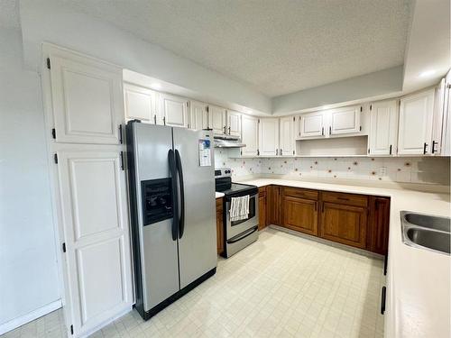 51 Harolds Hollow, Whitecourt, AB - Indoor Photo Showing Kitchen With Double Sink