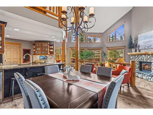 104 Silvertip Ridge, Canmore, AB - Indoor Photo Showing Dining Room With Fireplace
