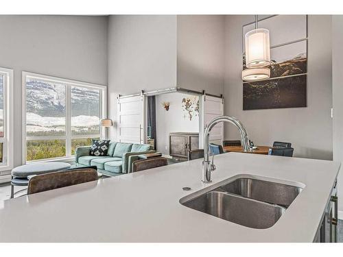 311-106 Stewart Creek Rise, Canmore, AB - Indoor Photo Showing Kitchen With Double Sink