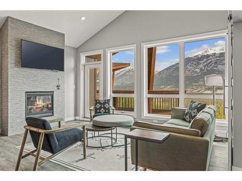 311-106 Stewart Creek Rise, Canmore, AB - Indoor Photo Showing Living Room With Fireplace