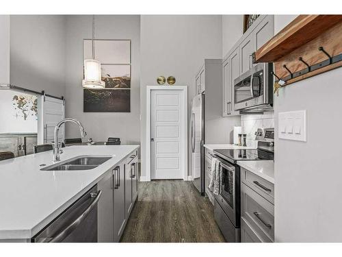 311-106 Stewart Creek Rise, Canmore, AB - Indoor Photo Showing Kitchen With Double Sink With Upgraded Kitchen