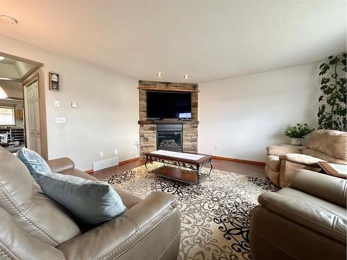 3623 & 3621 55 Ave, Whitecourt, AB - Indoor Photo Showing Living Room With Fireplace