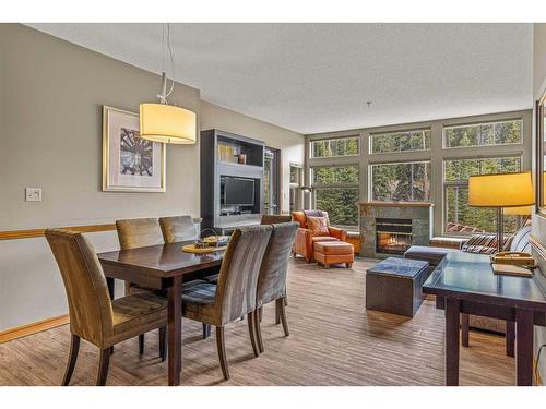 281-91B Three Sisters Drive, Canmore, AB - Indoor Photo Showing Dining Room With Fireplace