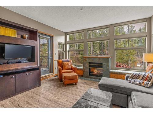 281-91B Three Sisters Drive, Canmore, AB - Indoor Photo Showing Living Room With Fireplace