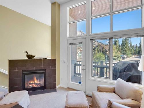 30 Antelope, Banff, AB - Indoor Photo Showing Living Room With Fireplace