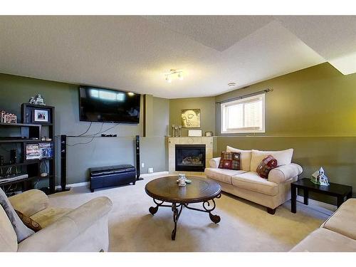 47 Springwood Drive Ne, Slave Lake, AB - Indoor Photo Showing Living Room With Fireplace