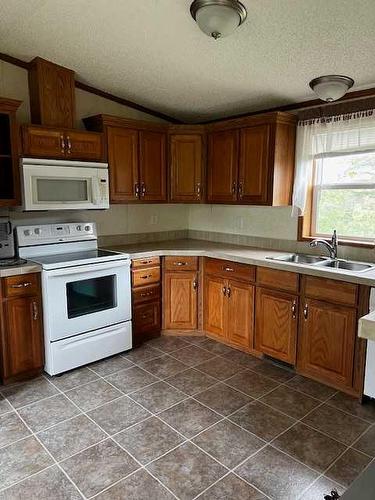 414 Grassy Way, Red Earth Creek, AB - Indoor Photo Showing Kitchen With Double Sink
