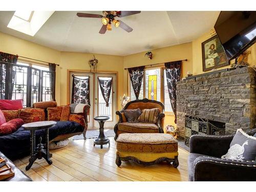 A&B-448 Elk Street, Banff, AB - Indoor Photo Showing Living Room With Fireplace