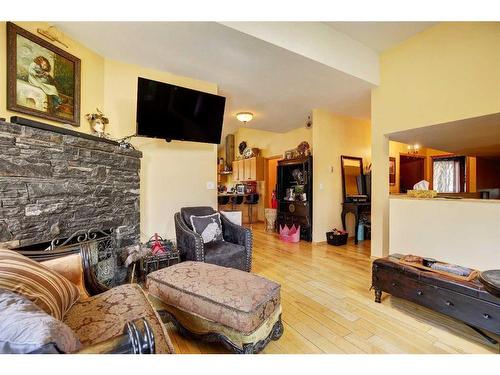 A&B-448 Elk Street, Banff, AB - Indoor Photo Showing Living Room With Fireplace