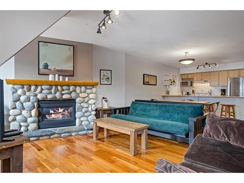 307-743 Railway Avenue, Canmore, AB - Indoor Photo Showing Living Room With Fireplace